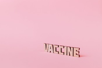 Vaccine Text on Pink Background