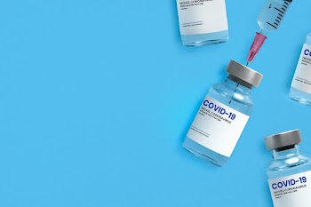 Vaccine vial mockup with a needle syringe background