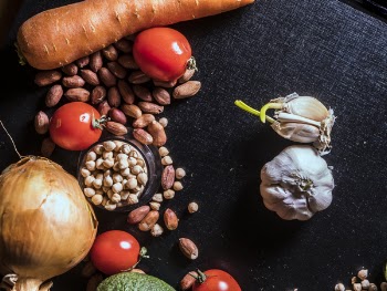 Variety of Spices and Vegetables on Black Surface