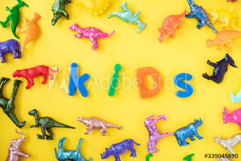 Various animal toy figures background with the word kids