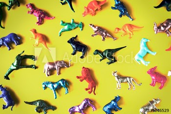 Various animal toy figures in a colorful background
