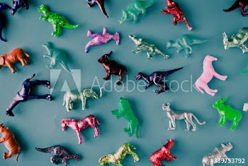 Various animal toy figures in a colorful background