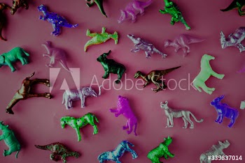 Various animal toy figures in a colorful background