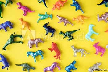 Various animal toy figures in a colorful background