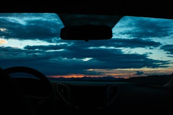 Vehicle Under Cloudy Sky During Golden Hour