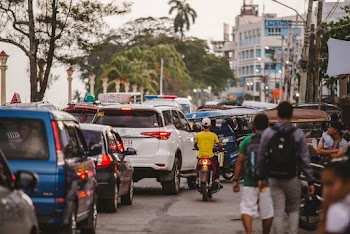 Vehicles Beside People Walking on Street
