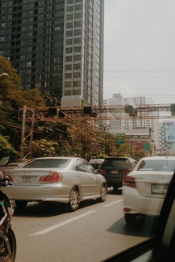 Vehicles in Busy Road Near Building