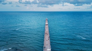 Vehicles on Bridge Viewing Blue Sea Under Blue Skies