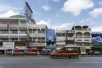 Vehicles on Road Beside Buildings