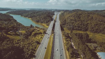 Vehicles on Road Under Blue Sky