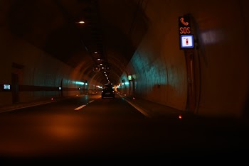 Vehicles on Tunnel Road at Nighttime