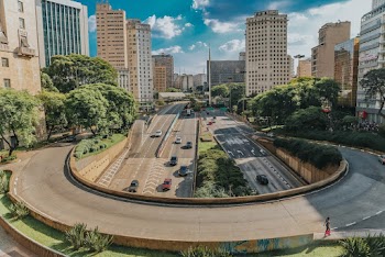 Vehicles Traveling on Road Near Buildings