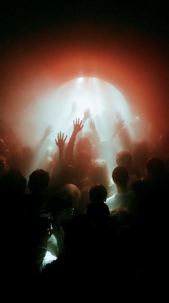 Vibrant Club Entrance with Hands Raised