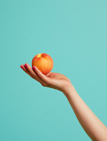 Vibrant Hand Holding a Peach