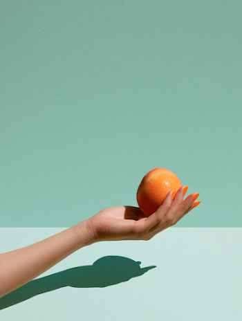 Vibrant Hand Holding a Peach
