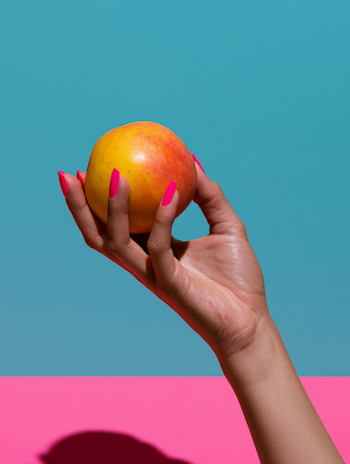 Vibrant Hand Holding a Peach Fruit