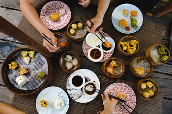 Vibrant shot of feasting on Chinese steamed and fried dim sum 