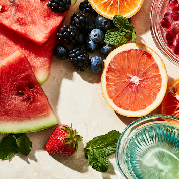 Vibrant Summer Fruit Arrangement on Pale Stone Surface