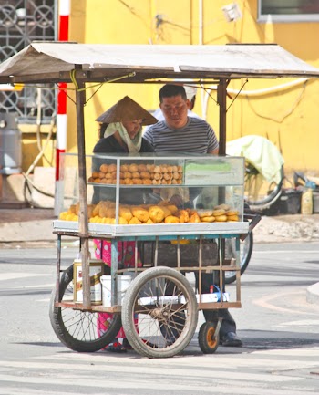 VIETNAM - JUNE 10 : A Vietnamese bread stall vendor sells bread along the road side. June 10, 2010 Ho Chi Minh City, Vietnam