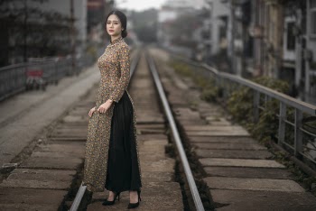 Vietnamese girl in Ao Dai on train road