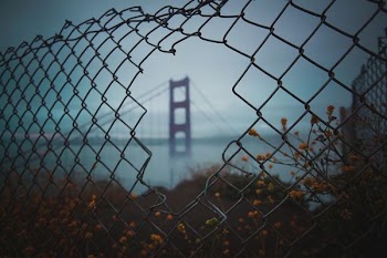 view a fence hole of San Francisco bridge