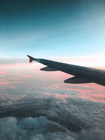 View of Airliner Wing Above the Clouds