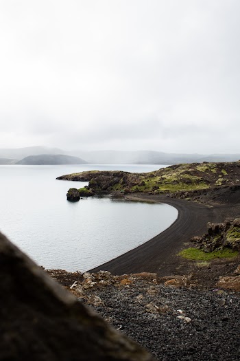 View Of An Island's Shore With Black Sand