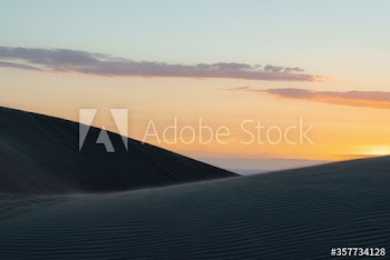 View of sand dunes during sunrise