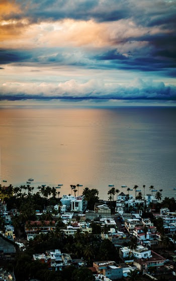 Village Near Shore Under White Sky
