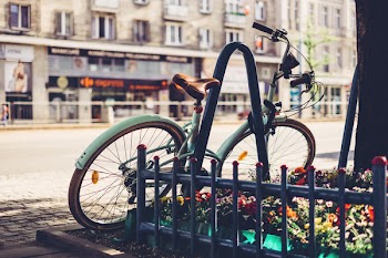 Vintage bicycle leaning against a bike rack 2
