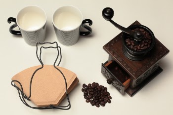 Vintage Brown Coffee Grinder on White Surface