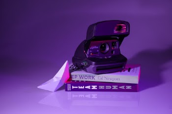 Vintage polaroid on top of amazing books.
