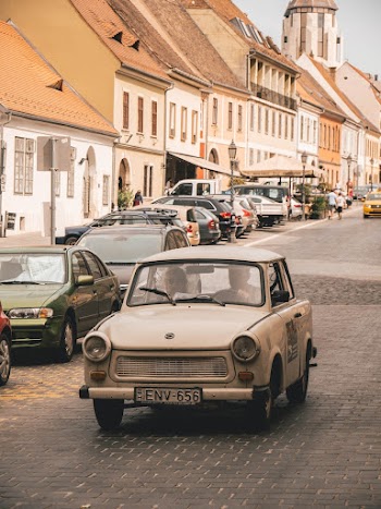 Vintage White Car Besides Cars