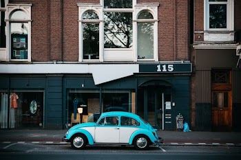 Volkswagen Beetle parking near building beside road
