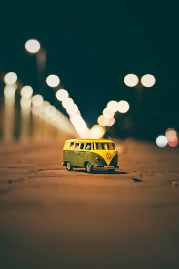 Volkswagen Van Diecast Model on Street With Bokeh Background