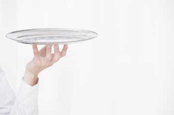 Waiter raising hand with metal tray Free Photo