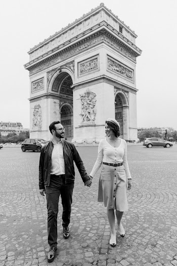 Walking Man And Woman Holding Hands Near Arc De Triomphe