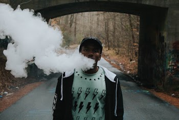 Walking While Smoking Near Bridge
