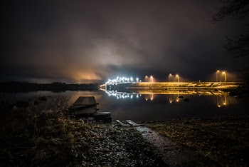 Walls With Lights Near Calm Body of Water at Night Time