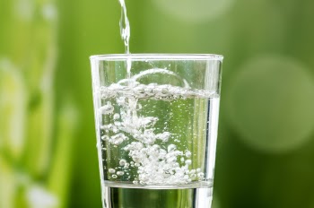 Water Pouring in Clear Drinking Glass