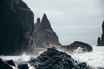 Water Splashing On Black Rock