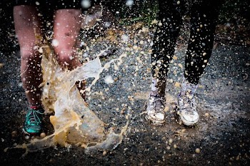 water splashing on two running people
