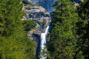 Waterfalls On Rocky Mountain Near Green-leafed Trees