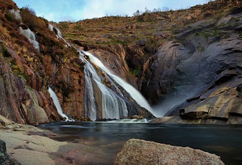 Waterfalls Surrounded With Rock Formation