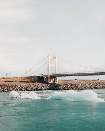 wave of body of water near bridge