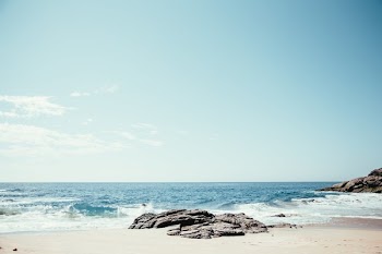 Waves Crash On Rocks And Sand
