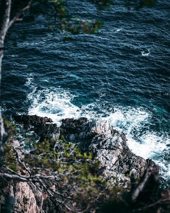 waves crashing on rock formation