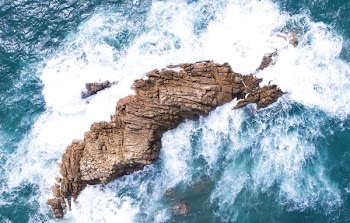 waves crashing on rock formation