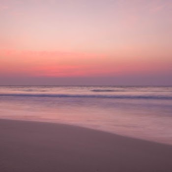 waves rushed to shore at sunset