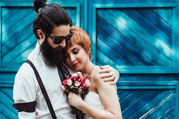 Wedding Couple Pre-nuptial Photo in Front Blue Wall